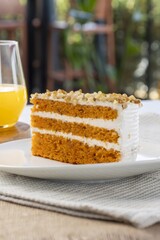 Slice of carrot cake with walnuts and cream cheese frosting