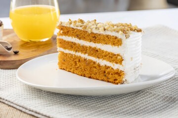 Carrot cake slice with walnuts and orange juice