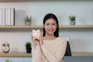 Financial Achievement: Woman Smiling with Piggy Bank