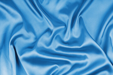 Crumpled, wrinkled cyan colored glossy silk satin texture. Shiny smooth fabric with soft folds,...
