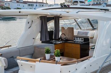 A cozy yacht galley and lounge area with modern kitchen appliances and stylish wooden accents at Limassol Marina