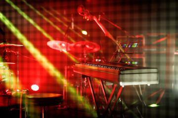 Red-lit stage with keyboard, drums, and double bass