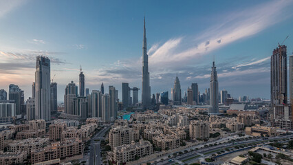 Fototapeta premium Dubai Downtown skyline day to night timelapse with Burj Khalifa and other towers panoramic view from the top in Dubai