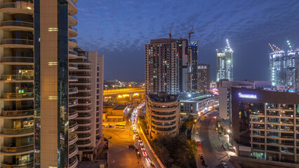 Fototapeta premium Dubai Marina skyscrapers, port with luxury yachts and Marina promenade aerial day to night timelapse, Dubai, United Arab Emirates