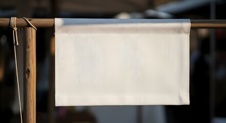 Blank canvas hanging on a wooden frame in a market setting, perfect for customized signage or branding opportunities to attract potential customers and clients.
