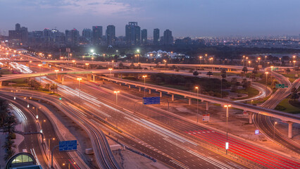 Fototapeta premium Aerial top view to Sheikh Zayed road near Dubai Marina and JLT night to day timelapse, Dubai.