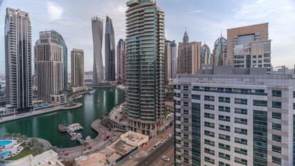 Obraz premium Aerial view of Dubai Marina residential and office skyscrapers with waterfront timelapse