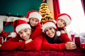 Happy family enjoying Christmas together in cozy home with festive tree and holiday spirit inside...