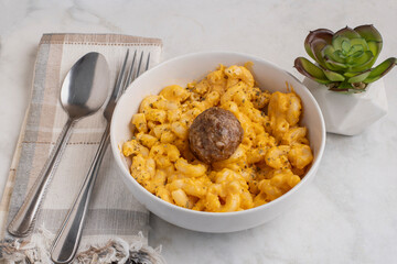 macaroni and cheese  with an italoan style meatball