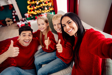 Family enjoying Christmas celebration together in cozy decorated home with happiness and festive...