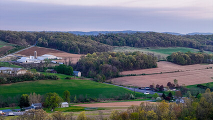 Naklejka premium Aerial landscape of corn fields farmland mountains sunset rural Appalachia Central Pennsylvania