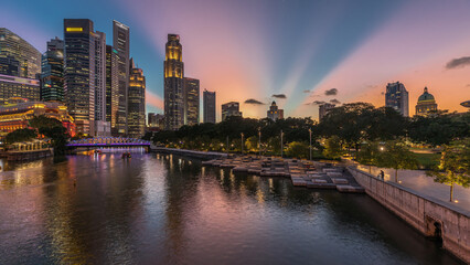 Singapore skyscrapers skyline with white Anderson Bridge near esplanade park day to night timelapse.