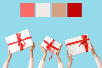 Hands holding Christmas gifts on blue background. Different color patterns