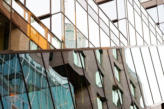 Modern architecture with overlapping layers of glass and steel forming abstract geometric reflections, clean textures, and a balanced structure that define a contemporary minimal background aesthetic