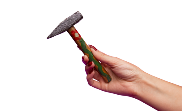 A young woman's hand is holding a decorated hammer with sparkles and a flower painted on the handle. Hammer in a woman's hand isolated transparent