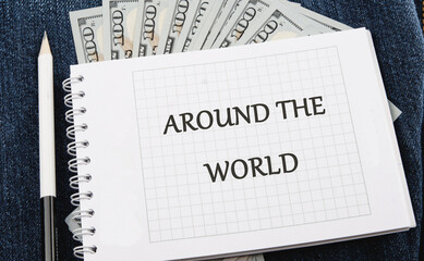 A spiral notebook lies open, featuring the phrase Around the World, surrounded by crisp hundred dollar bills, symbolizing travel dreams and financial aspirations for everyone
