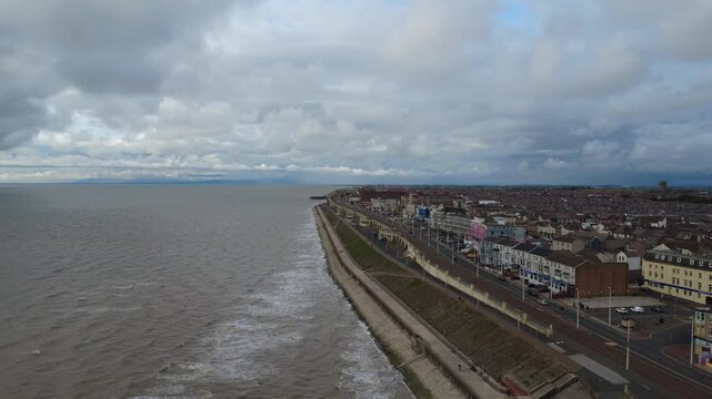 aerial drone view of the promenade in north blackpool with hotels along the seafront and promenade