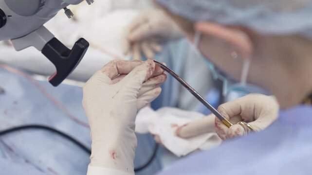 Tympanoplasty, trimming a sample of the temporalis muscle fascia for eardrum implantation