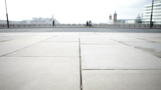 London City footfall. A candid view with abstract close focus on road and pedestrian traffic crossing London Bridge.