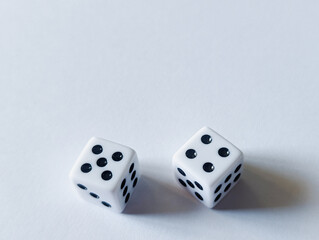 horizontal conceptual photo of two white dice showing five and four on a clean white background