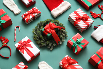 Composition with Christmas gifts and decor on green background