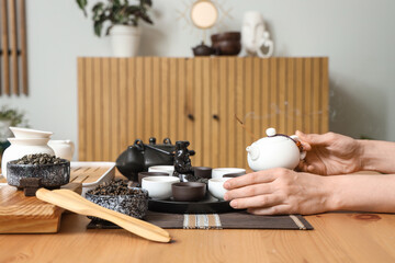 Person during Chinese tea ceremony at home