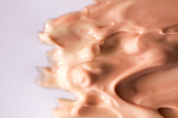 Liquid product sample smear with delicate flow pattern. A tactile image of modern skincare design.