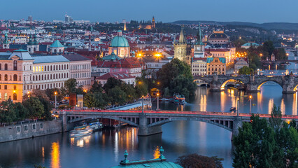 Aerial evening view of the Vltava River and illuminated bridges day to night timelapse, Prague