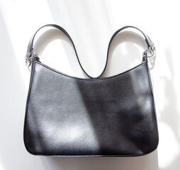 Black leather fashion bag on a white background.