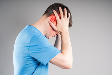 Headache and migraine, man with head pain on gray background