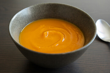 pumpkin puree in dark bowl close up