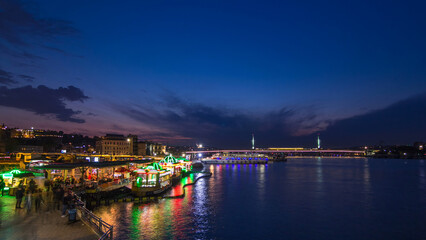 Fototapeta premium Passenger Ferries in the Golden Horn after sunset day to night timelapse, Istanbul skyline, Turkey