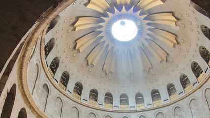 Crowd of people and ray of sun from dome in the Church of the Holy Sepulcher timelapse.