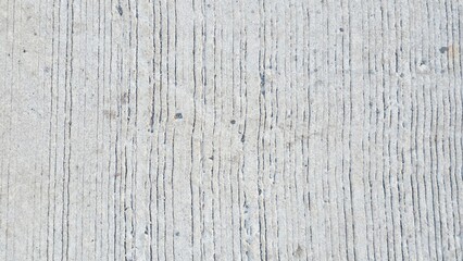 Obraz premium Close-Up View of Light Gray Textured Concrete Surface with Vertical Grooves and Lines