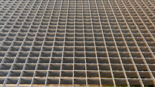 Metal grate floor with rectangular cells, perspective view. Horizontal background.