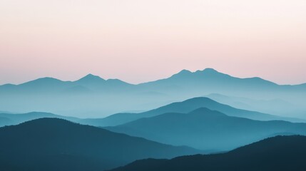 Beautiful mountain landscape with layers of peaks under a pastel sky during twilight