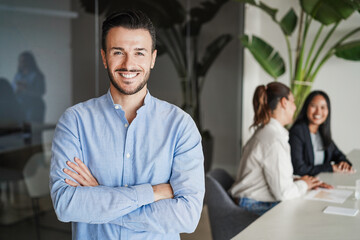 Caucasian business man smiling on camera inside corporate office - Entrepreneur and career concept - Focus on face