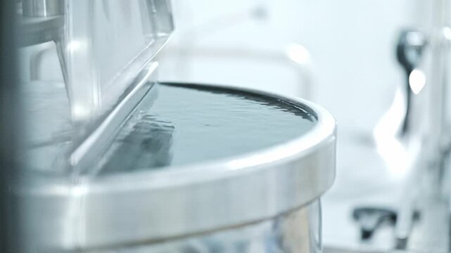 A large stainless steel water tank in a factory