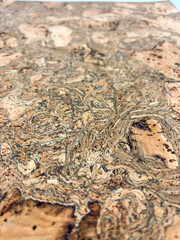 Macro close-up of wavy grain cork veneer surface with complex organic patterns and texture.
