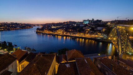 Obraz premium Panorama of old city Porto at river Duoro after sunset day to night timelapse, Oporto, Portugal