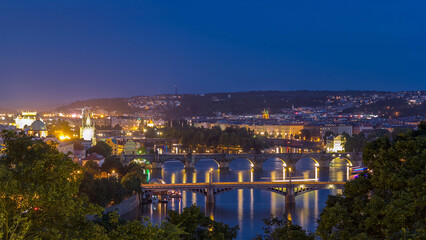 Fototapeta premium Scenic view of bridges on the Vltava river day to night timelapse and of the historical center of Prague: buildings