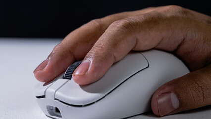 Macro shot of fingers on white mouse scroll wheel, focus on detail and texture, concept of technology control and accurate navigation.