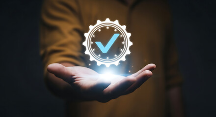A person's hand presenting a glowing checkmark icon, symbolizing approval and quality assurance.