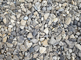 Textured gravel surface with varying stone sizes ideal for construction or landscaping projects