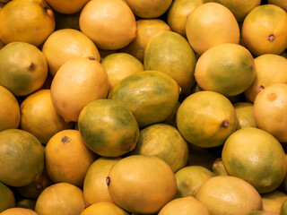Vibrant display of fresh yellow and green lemons