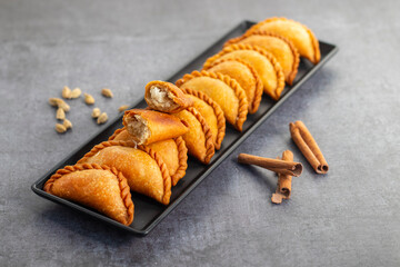Gujia is a crispy, crescent-shaped Indian sweet filled with khoya, coconut, and dry fruits, traditionally enjoyed during Holi festival.
