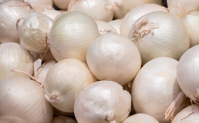 A large pile of fresh whole white onions background