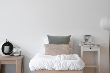 Interior of hotel room with bed, tables and coffee machine