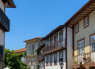 Picturesque old European city street with colorful historic buildings and stone facades. Quiet