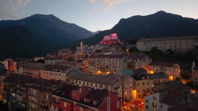 Aerial view of medieval citadel Belvedere amidst vibrant landscape and distant peaks. Corte. Corsica. France